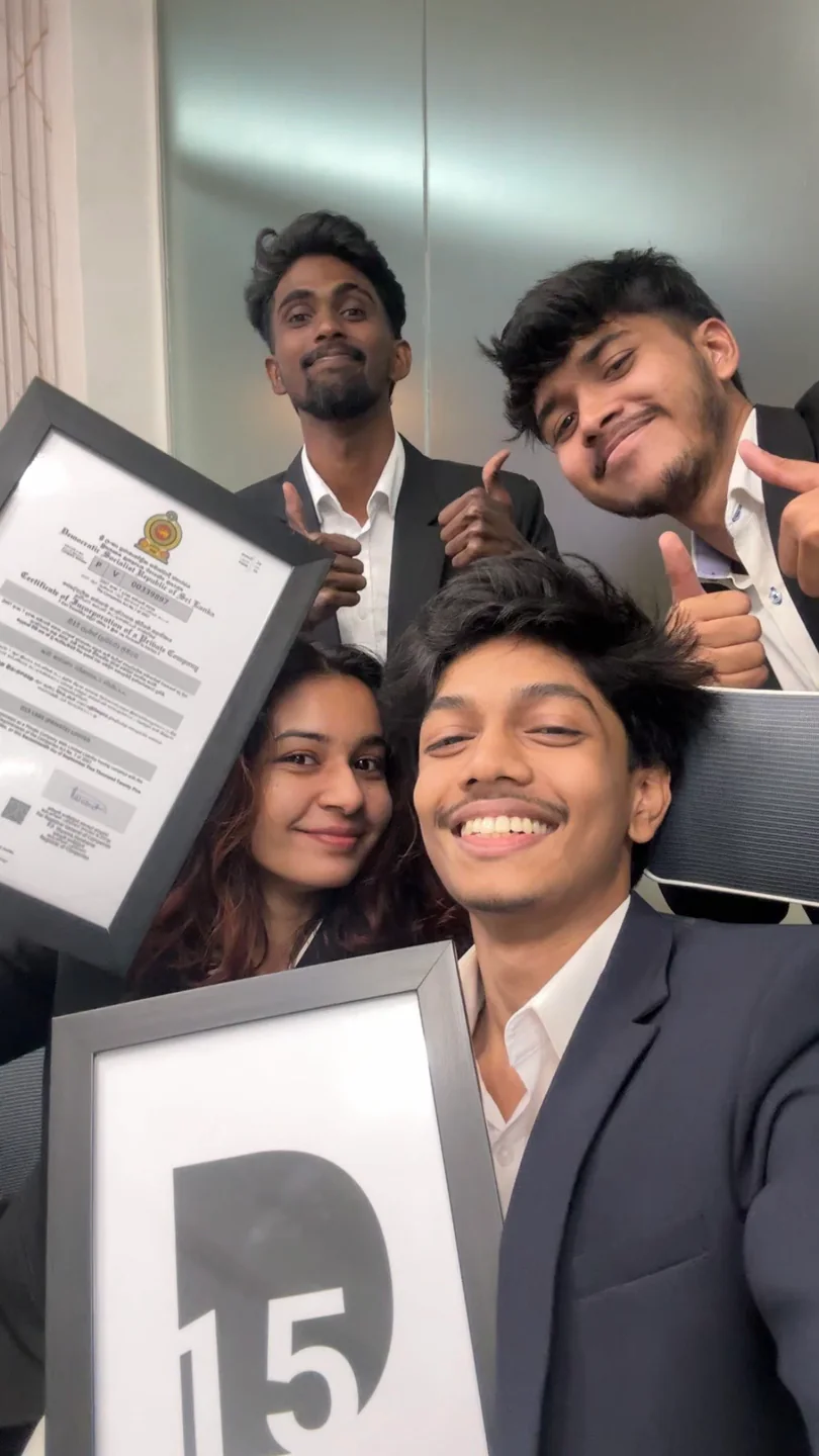 D15 Labs team holding the company's certificate of incorporation and a framed D15 logo