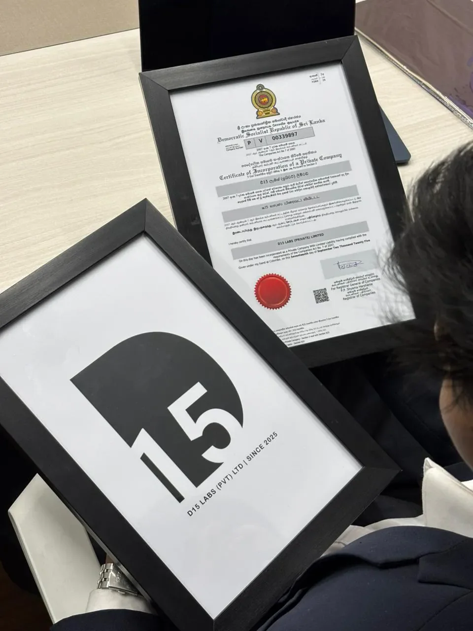 Framed D15 Labs logo beside the certificate of incorporation